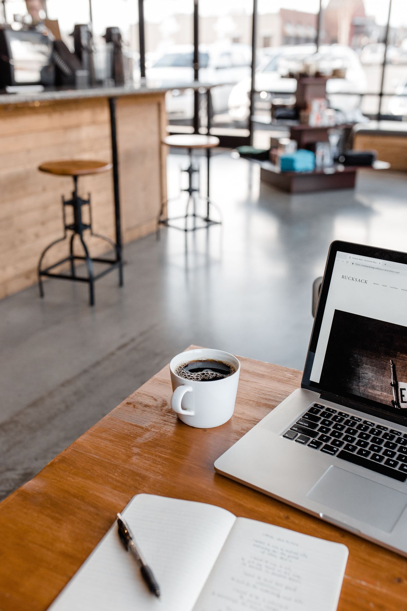 Workspace with laptop and notebook at a cafe